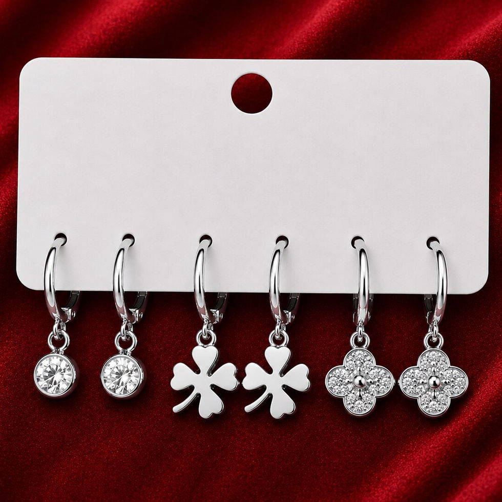 Silver anti-tarnish hoop earring set featuring crystal drop charms, lucky clover charms, and floral statement charms displaye