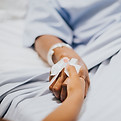 daughter-holding-her-mothers-hand-hospital.jpg