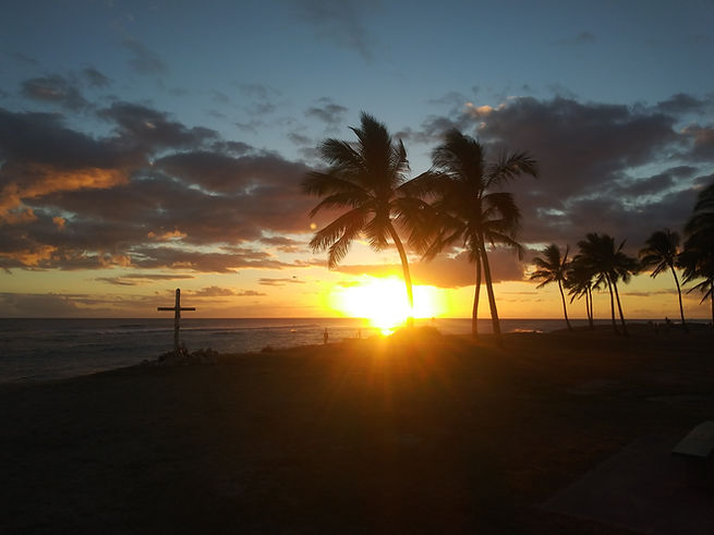 West O'ahu sunset with the Cross of Christ and palm trees