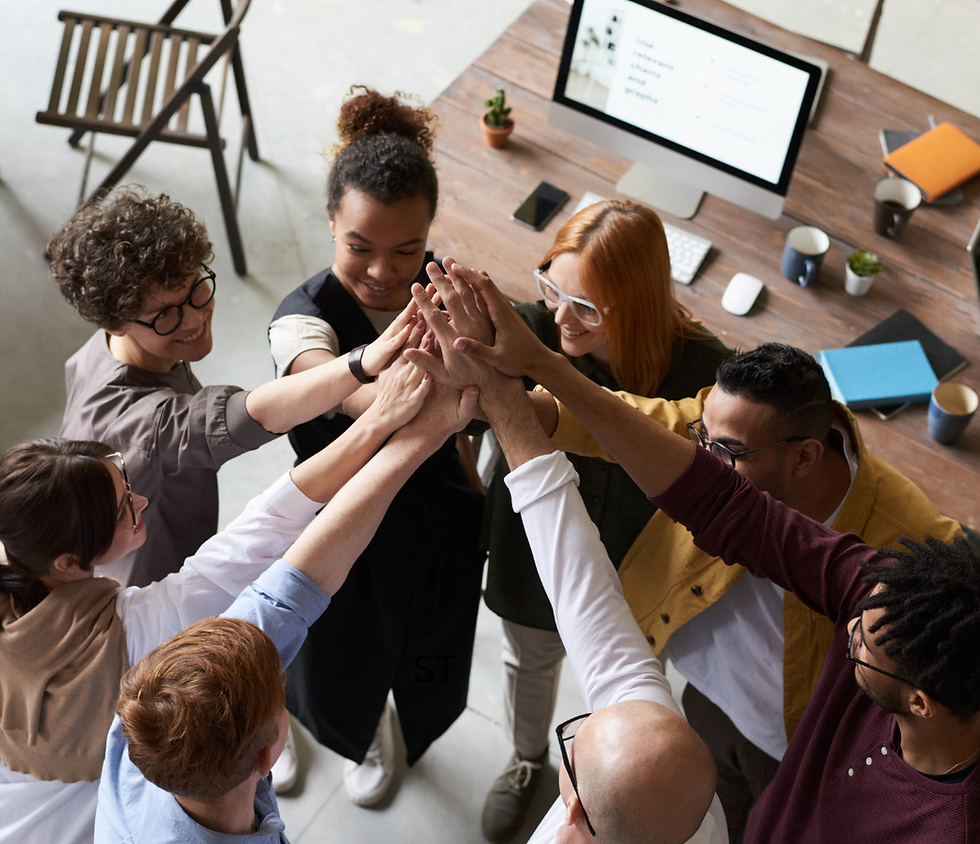 alt="a team cheering in a high five"