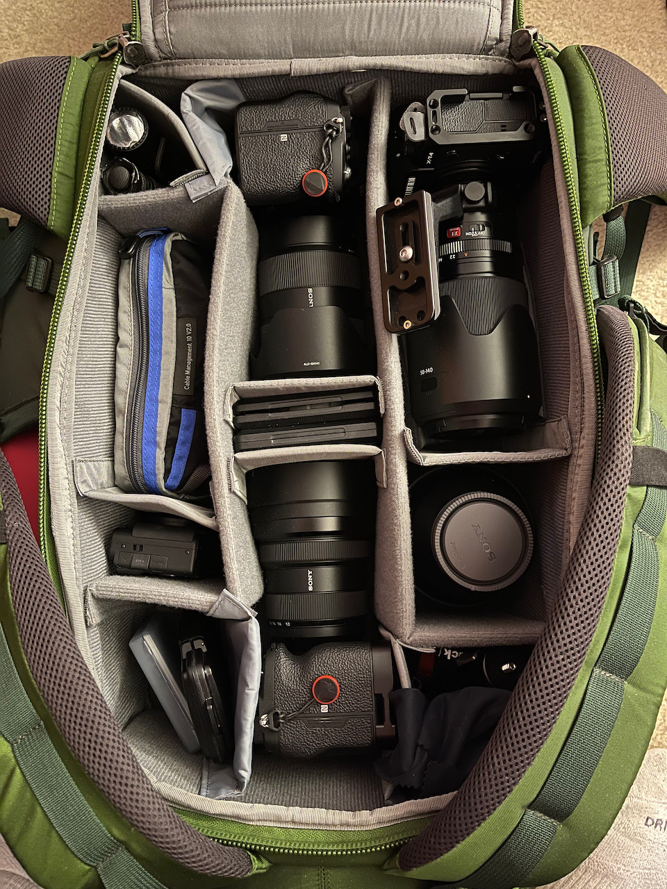 A green camera bag perfectly contains every last bit of gear needed for a professional photographer