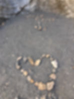 Small rocks spell out "The End" and depict a heart along Mosaic Valley Trail in Death Valley National Park, California