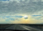 The sun scorches its way through the clouds over the road through the Chihuahuan desert in West Texas