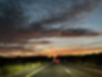 Spooky clouds pepper the skyline as the sun rises over Route 10 in Southern Arizona