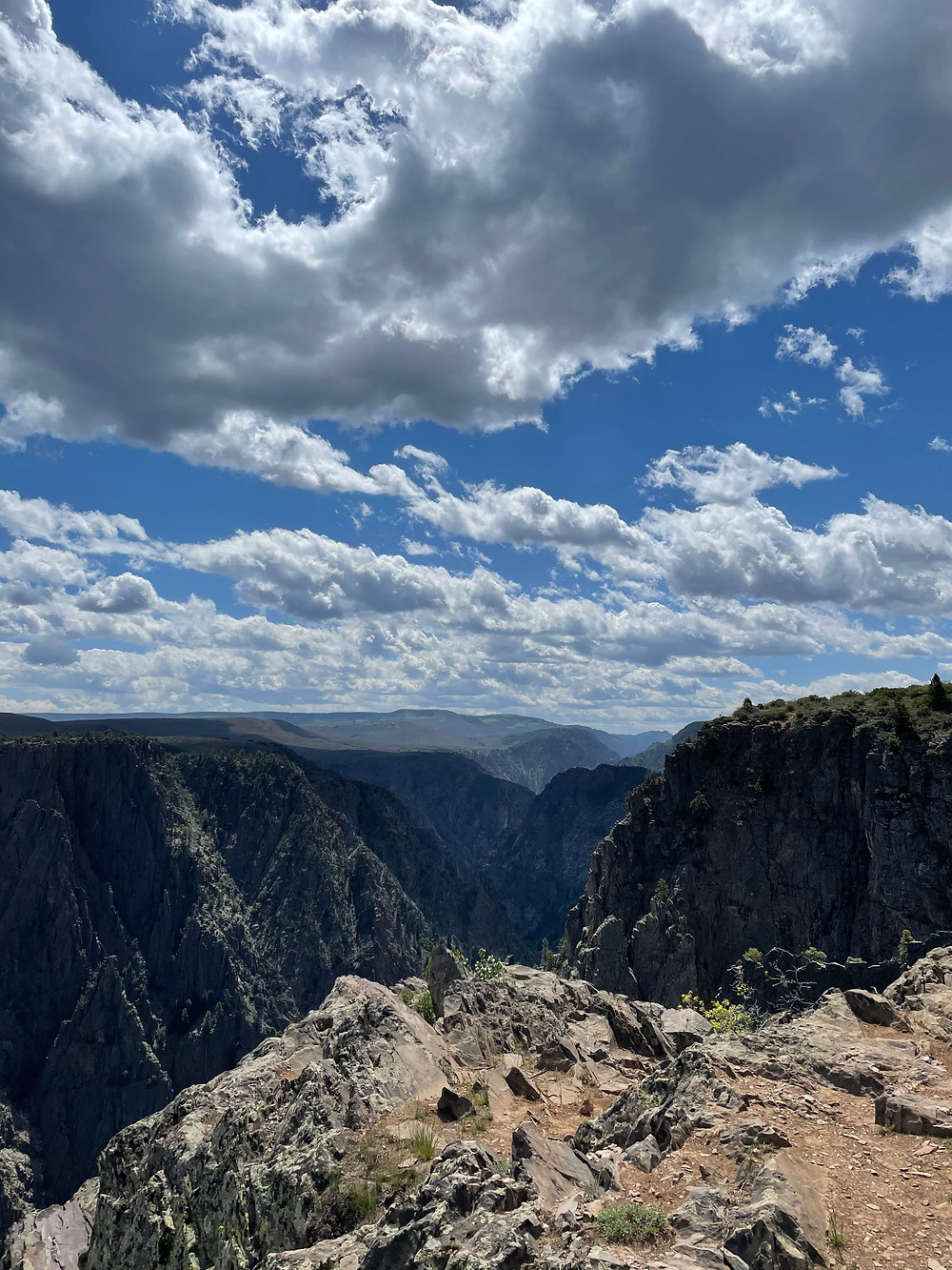 Beautiful blue skies and fluffy clouds over Black Canyon of the Gunnison National Park in Colorado