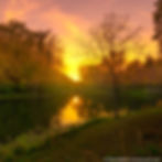 sunset over Hot Springs National Park in Arkansas providing inspiration in the form of brilliant pinks, purples, oranges, and yellows cascading over a pond