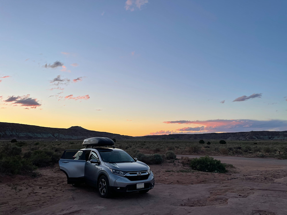 A Honda looking totally badass parked in front of a muted sunset in Moab, Utah