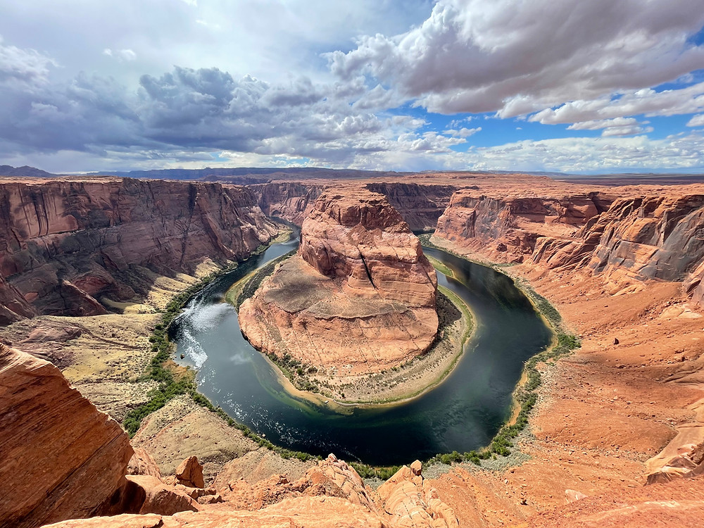 The Colorado River's impossible hairpin turn around a red rock structure makes up Horseshoe Bend in Page, Arizona