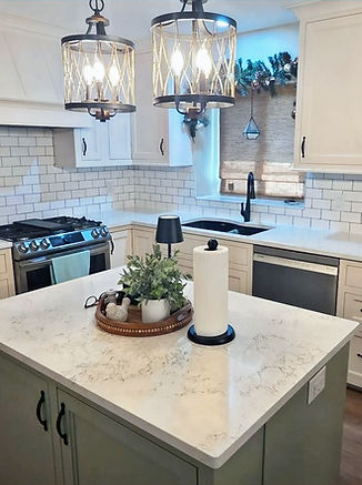 Kitchen remodel with white cabinets, quartz countertops and a white subway tile backsplash