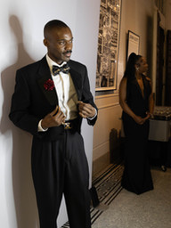 Groomsman preparing for photos at a luxury wedding photo booth in New Orleans.