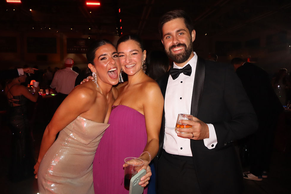 Three formally dressed guests smiling and posing at The Capital Gala in Baton Rouge during the Best Dressed fundraiser, captured inside the Spotlight Booth experience.