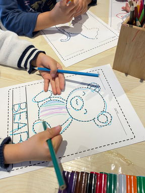 child tracing picture of a bear
