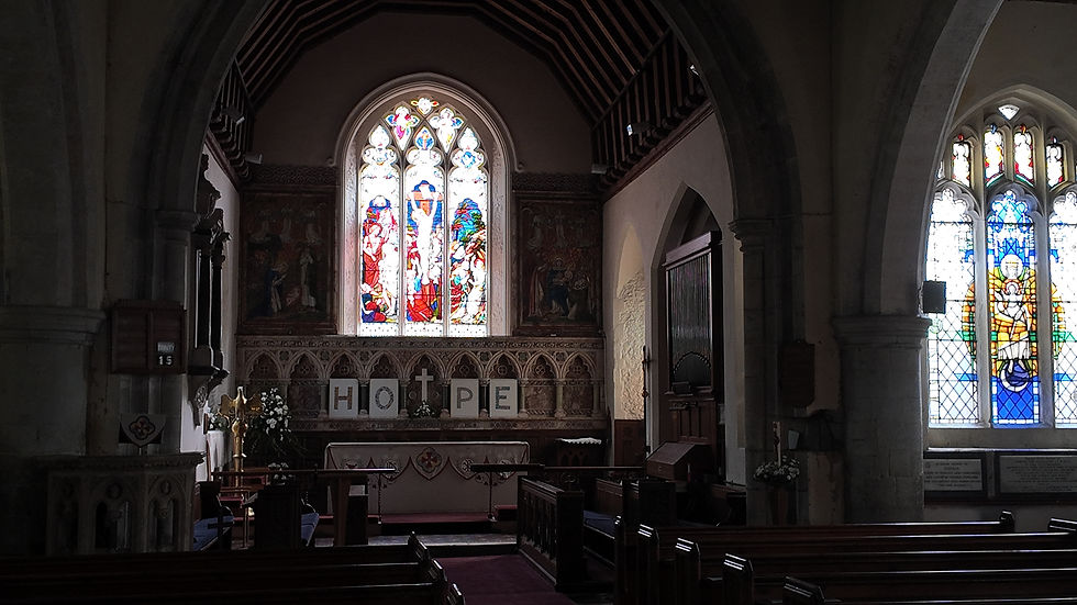 Quiet church interior with stained glass windows, altar letters spelling HOPE, dark pews, and soft light.