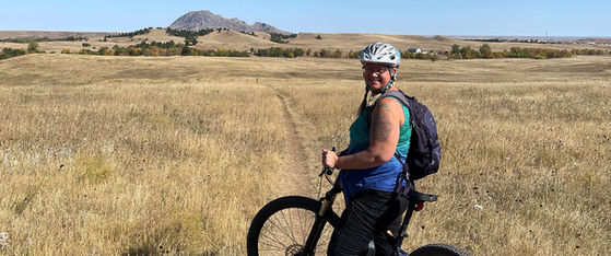 Biker stops for a photo during her biking tour of the Badlands