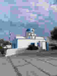 Blue domed Greek church on the path between Oia and Fira in Santorini Greece