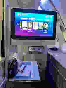 Tv in British Airways Club World pulls out from the left wall of the cubicle