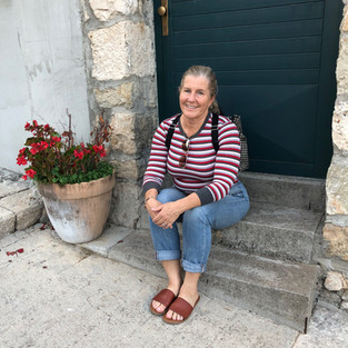 Siri Kay Jostad of Wander Away with Siri Kay resting on stone steps in Split Croatia
