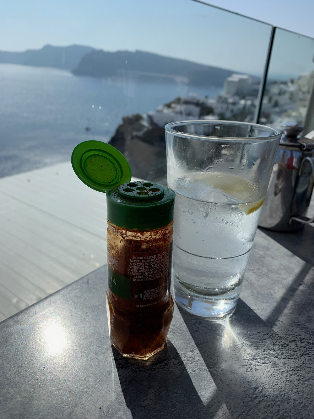 Achaar masala on a table with a view of the caldera in Oia Santorini Greece