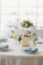 Wedding and Event Florals on a white reception table.