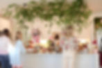 Wedding and event florals with hanging greenery over buffet