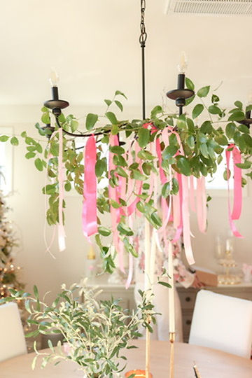 Chandelier with greenery and pink ribbons by a Mobile, AL florist