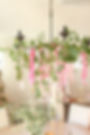 Chandelier with greenery and ribbons for wedding and event florals