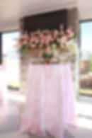 Pink wedding and event florals on a fireplace mantel