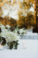 White wedding and event florals on an outdoor table.