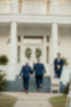 Couple entering a venue with wedding and event florals.