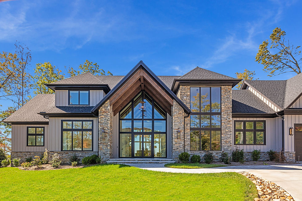 Custom mountain modern home exterior with stone façade and tailored landscaping in The Cliffs Commun