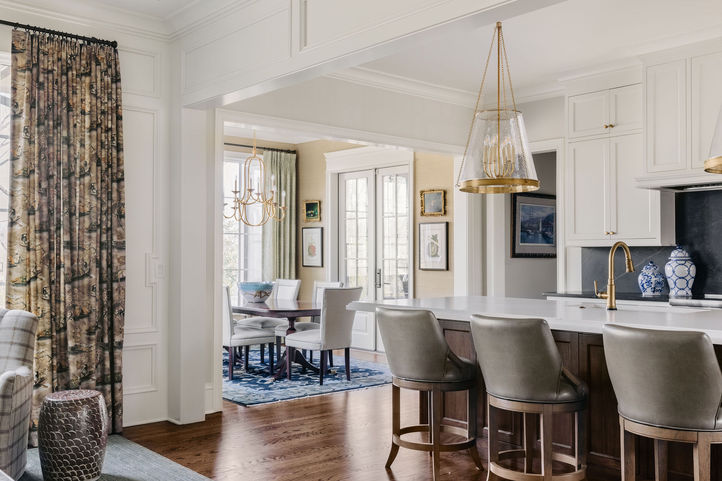 Open-concept luxury home with custom kitchen and living room designed by Fowler Interiors
