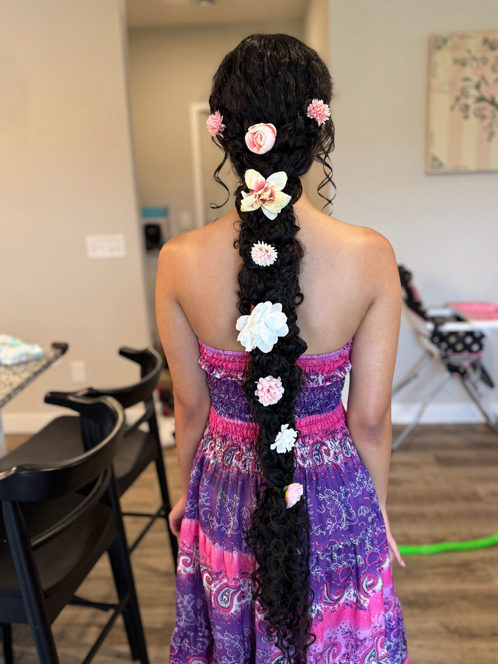 Long braided hair with pink and white flowers