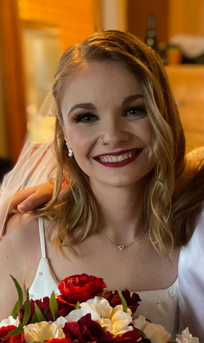 Smiling woman holding red and white flowers