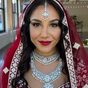 Woman in red traditional dress, silver necklace, and headpiece