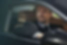 Security chauffeur ensuring safety in luxury vehicle during transit.