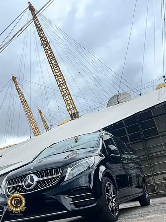 Crownwood Charters Mercedes V-Class chauffeur vehicle parked outside The O2 Arena London for a private group concert transfer.