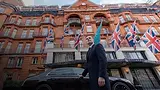 Crownwood Charters chauffeur in a dark suit outside Claridge’s hotel in Mayfair, London, beside a chauffeur car