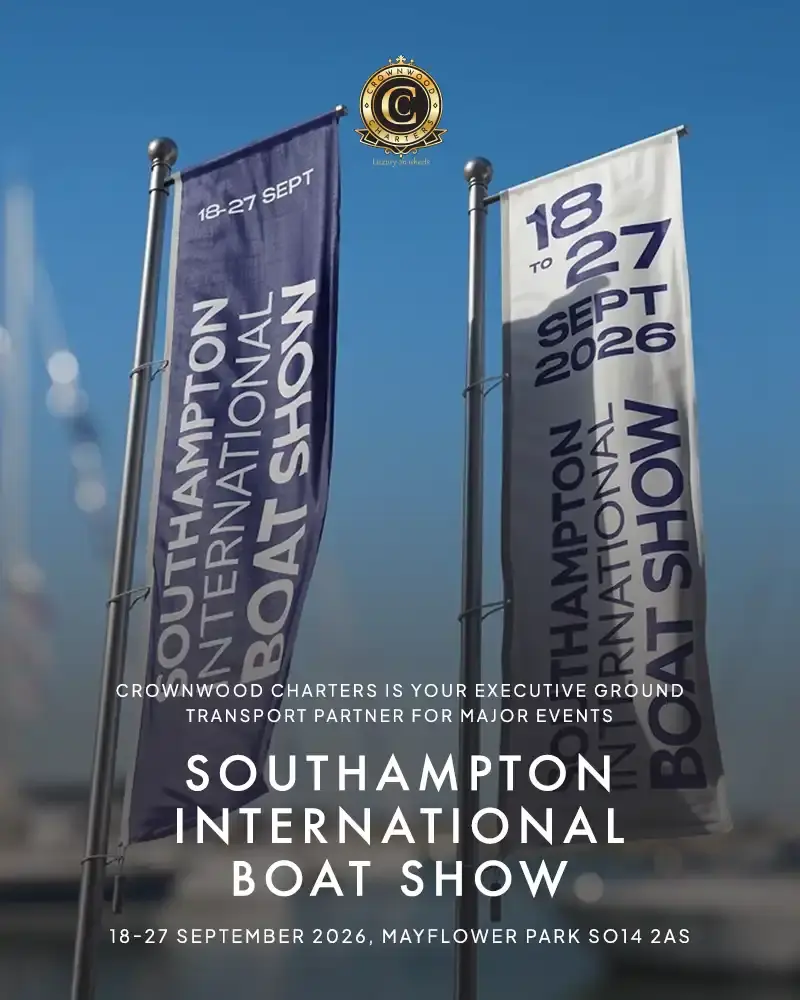 Two Vertical Banners Flying Against A Blue Sky Displaying Southampton International Boat Show Dates 18-27 September 2026 At Mayflower Park SO14 2AS With Crownwood Charters Logo And Executive Transport Service Text Overhead.