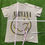 Thumbnail: 2023 NIRVANA SMILEY FACE BAND TEE TAN