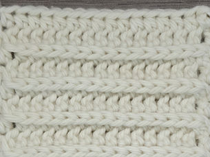 Close-up of cream yarn worked in rows of Half Double Crochet through the front bottom loop
