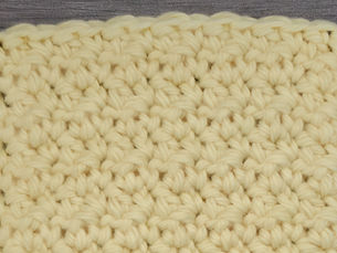 Close-up of yarn worked in the Crumpled Griddle Stitch with alternating Single Crochet and Double Crochet Stitches.