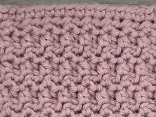 Close-up of pink yarn worked in the textured Mixed Loop stitch
