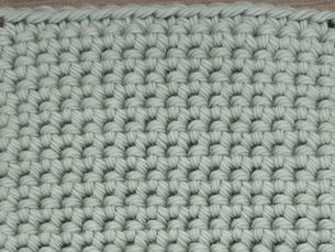 Close-up of yarn crocheted in the Thermal Stitch, showing a thick, double-layered fabric with compact horizontal rows.