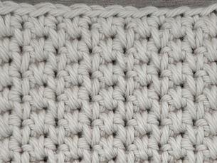Close-up of yarn crocheted in the Alternate Spikes stitch, showing staggered elongated Single Crochet stitches.