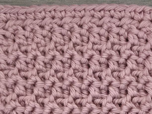 Close-up of pink yarn worked in the textured Even Mixed Loop Stitch