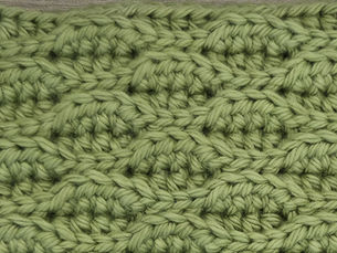 Close-up of yarn worked in the Almond Ridges stitch with alternating raised ridges.