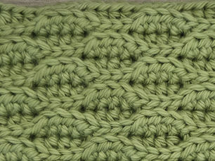Close-up of yarn worked in the Almond Ridges stitch with alternating raised ridges.