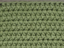 Close-up of yarn worked in Wide Half Double Crochet between the stitches of the previous row.