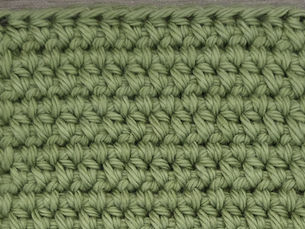 Close-up of yarn worked in Wide Half Double Crochet between the stitches of the previous row.