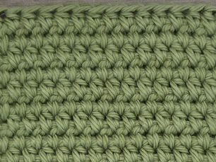 Close-up of yarn worked in Wide Half Double Crochet between the stitches of the previous row.